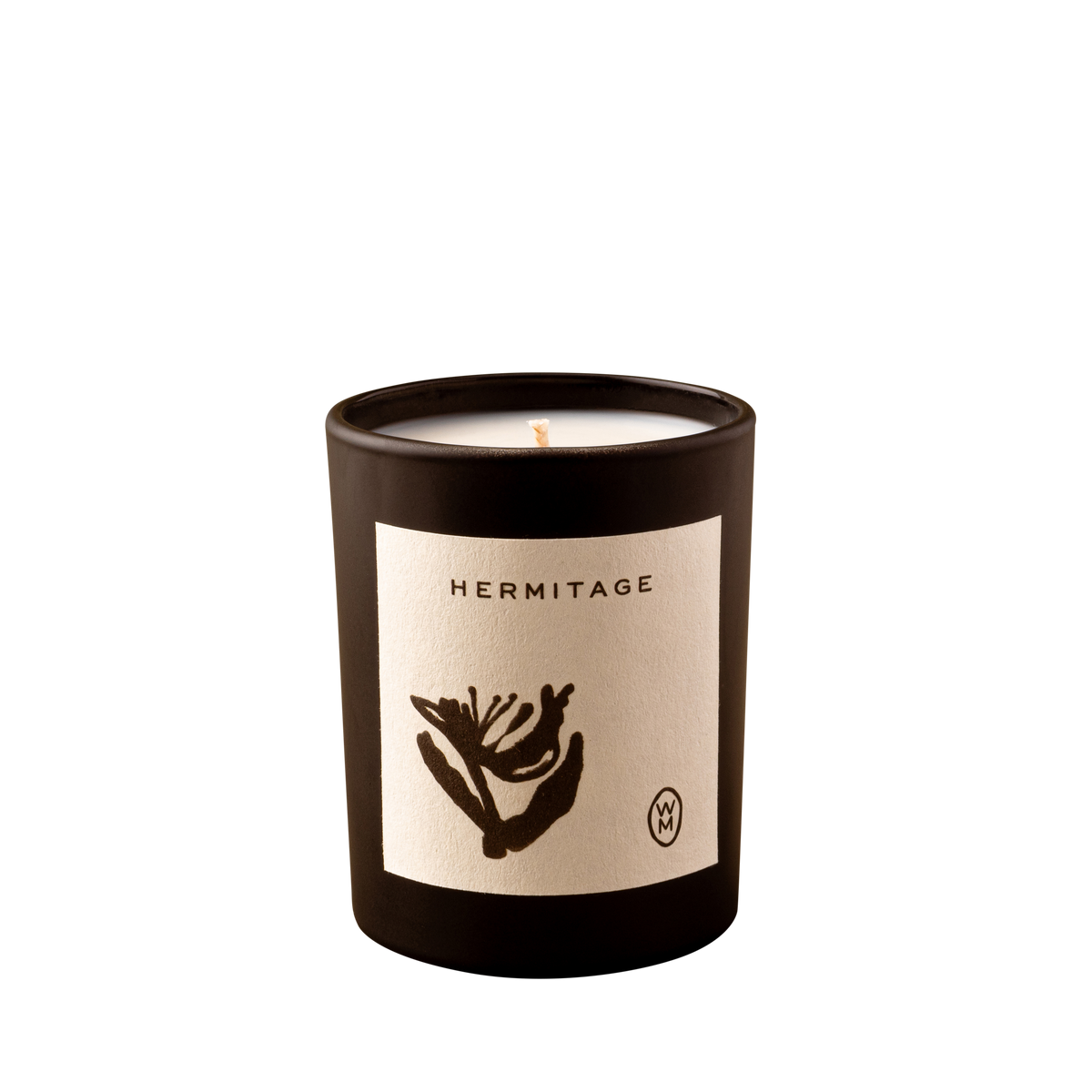 Candle in a black container with 'Hermitage' label on a white background