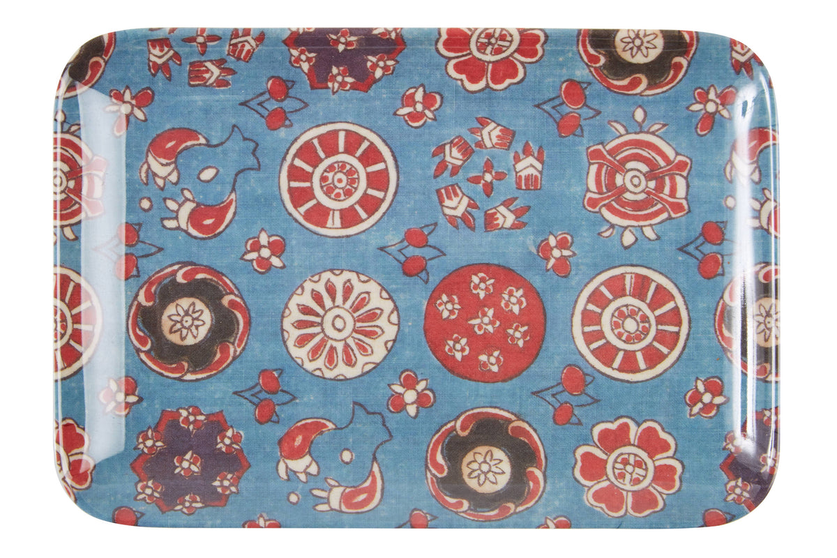 Decorative tray with black, white and red floral pattern on a blue background