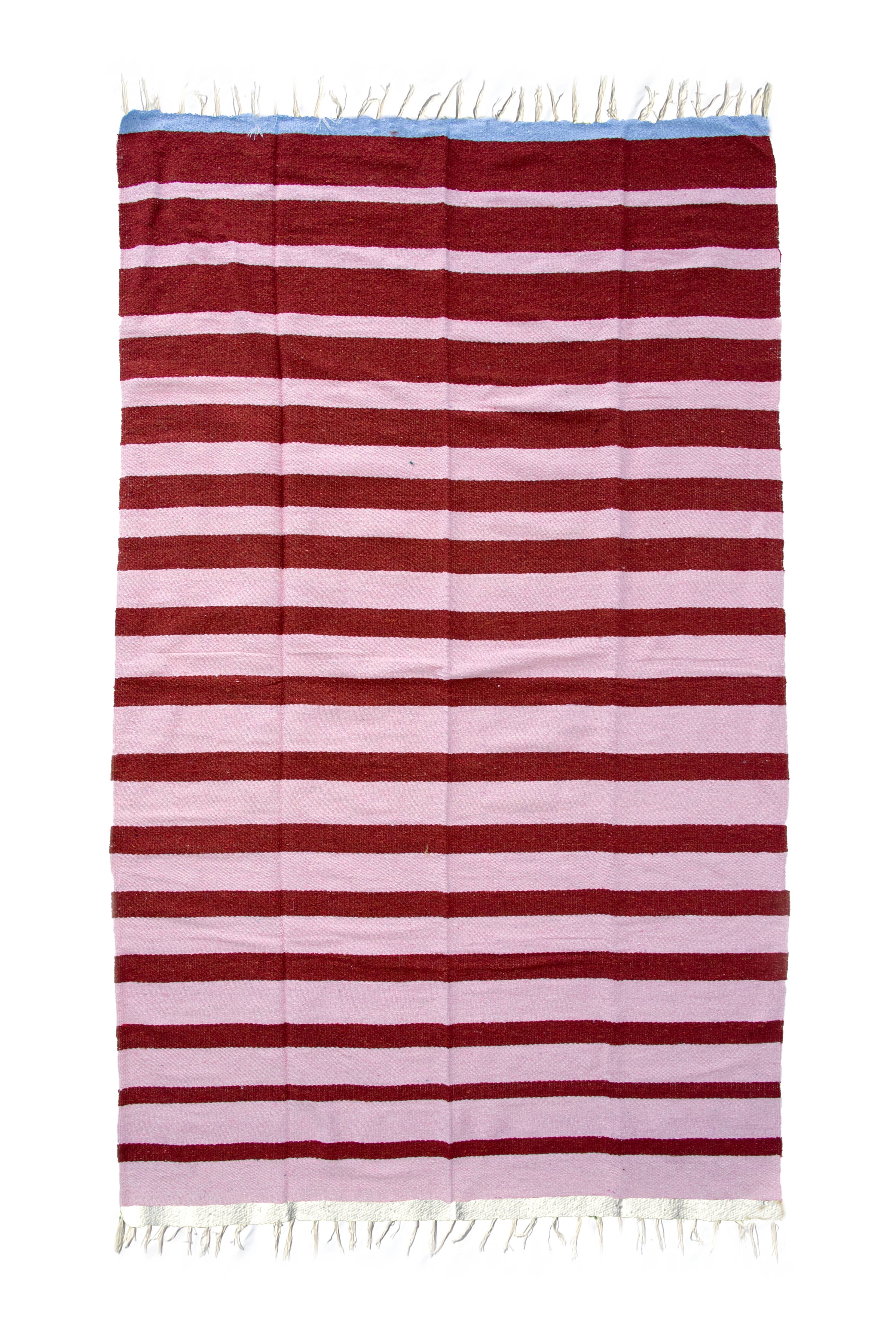 Striped blanket with red and white horizontal stripes on a white background
