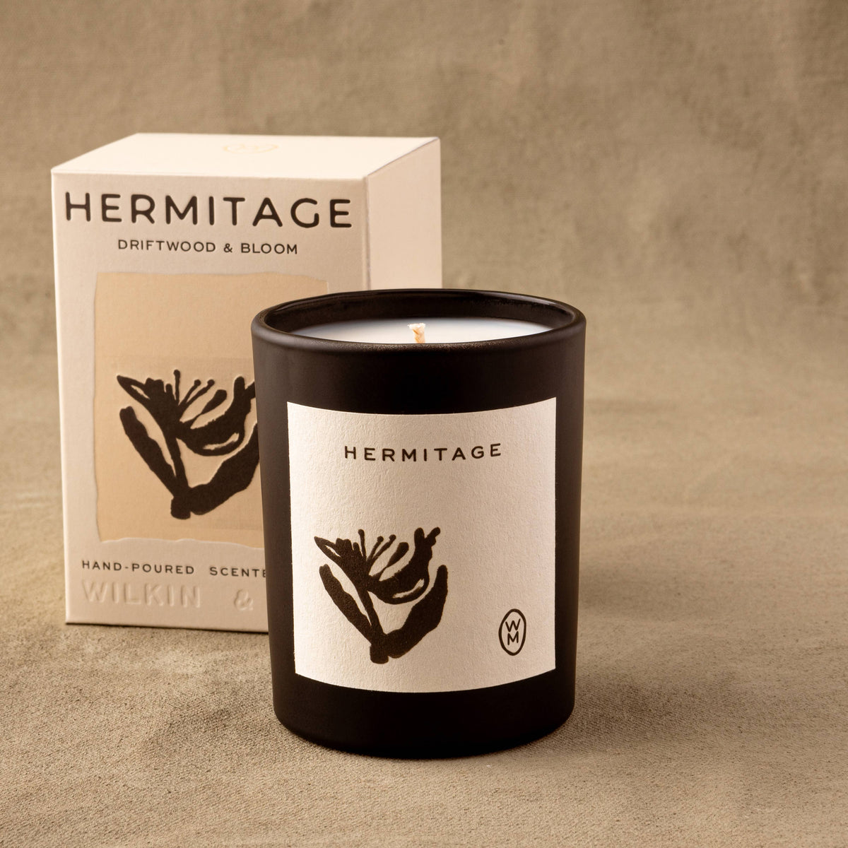 Hermitage candle with packaging on a beige background