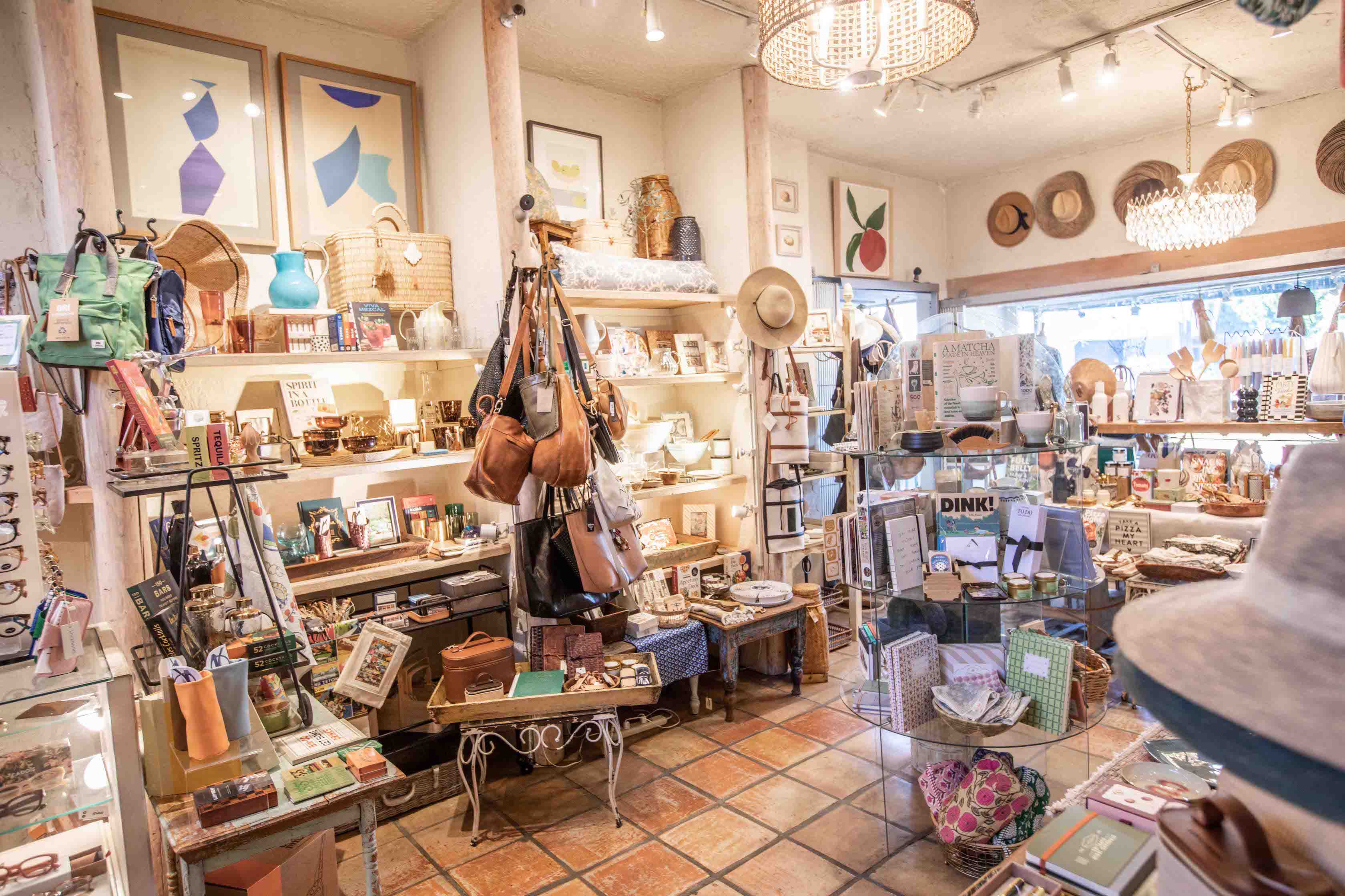 Interior of a store with various products on shelves and tables.