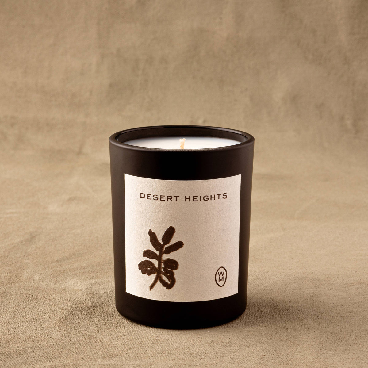 Candle with 'Desert Heights' label on a beige background